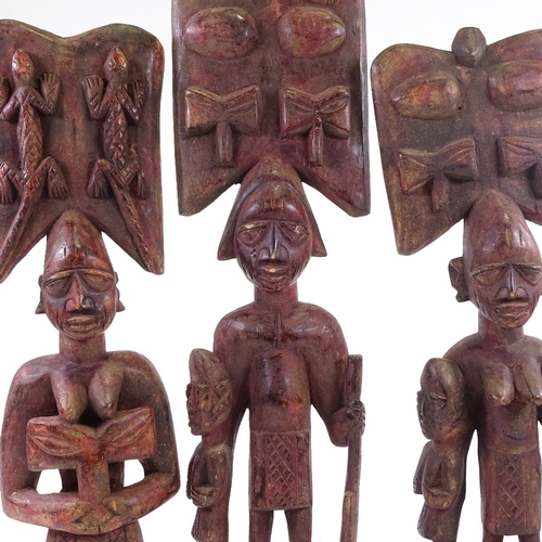 203 - 3 carved wood African figures, stained red, tallest 64cm.