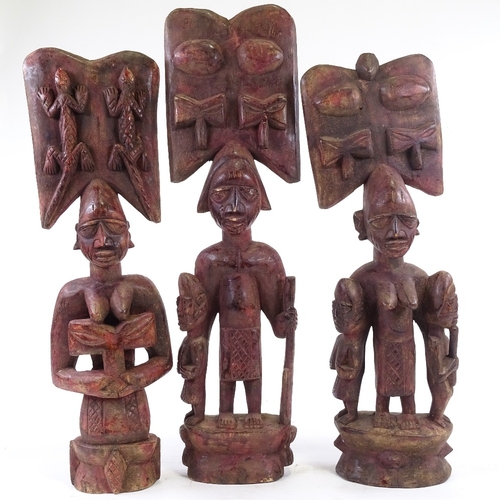 203 - 3 carved wood African figures, stained red, tallest 64cm.