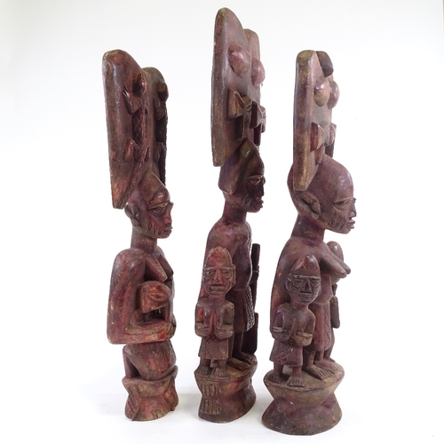 203 - 3 carved wood African figures, stained red, tallest 64cm.