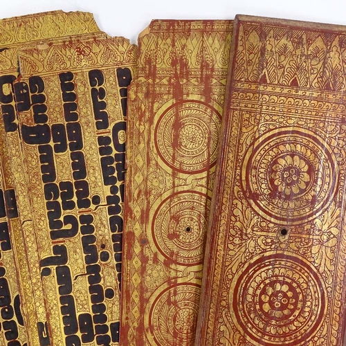 68 - A 19th century Burmese palm leaf prayer book, with gilded and lacquered wood covers, length 55cm