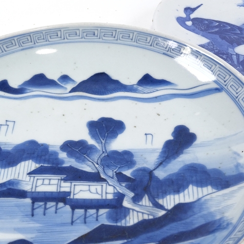 70 - A Japanese blue and white porcelain charger, with hand painted lake scene, diameter 31cm, and a blue... 