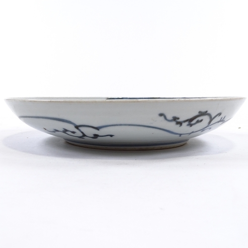 71 - A Japanese blue and white porcelain plate with hand painted figures, 4 character mark, diameter 29cm