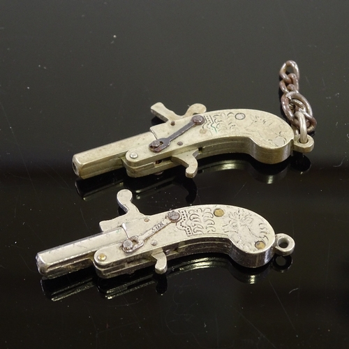 74 - A pair of miniature working steel pistols, length 4cm