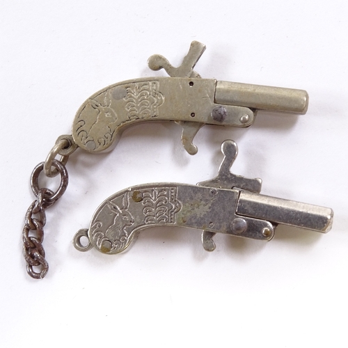 74 - A pair of miniature working steel pistols, length 4cm