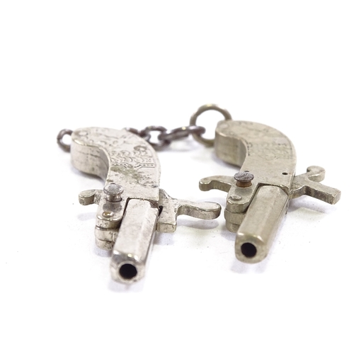 74 - A pair of miniature working steel pistols, length 4cm