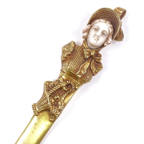 81 - A gilt-bronze and ivory paper knife, the relief cast handle in the form of a Victorian lady, unsigne... 