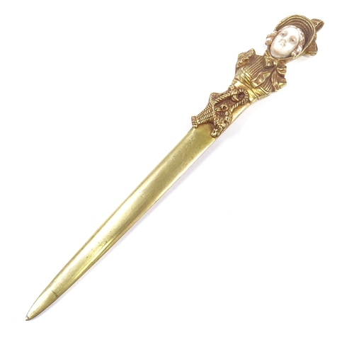 81 - A gilt-bronze and ivory paper knife, the relief cast handle in the form of a Victorian lady, unsigne... 