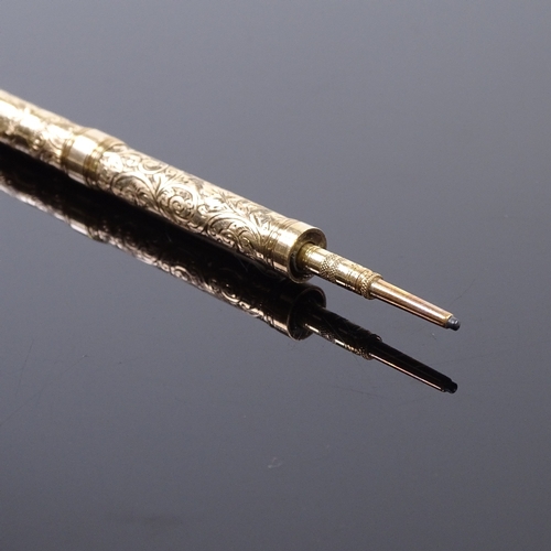 88 - A 9ct gold dual propelling pen/pencil, with engraved decoration, marked 9ct, open pen length 12cm.