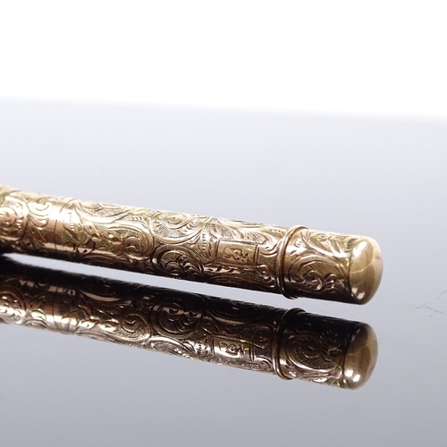 88 - A 9ct gold dual propelling pen/pencil, with engraved decoration, marked 9ct, open pen length 12cm.