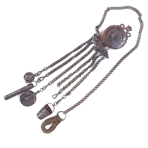 537 - A 19th century bright-cut steel chatelaine, target-shaped clip suspending 6 steel chains with thimbl... 