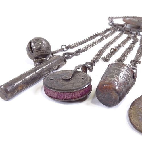 537 - A 19th century bright-cut steel chatelaine, target-shaped clip suspending 6 steel chains with thimbl... 