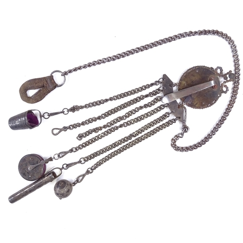 537 - A 19th century bright-cut steel chatelaine, target-shaped clip suspending 6 steel chains with thimbl... 