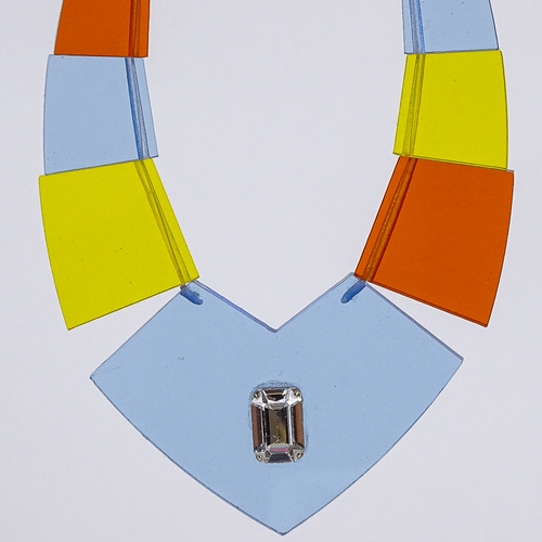 540 - A Vintage multi-colour transparent perspex panel costume necklace, inset paste stone in central pane... 