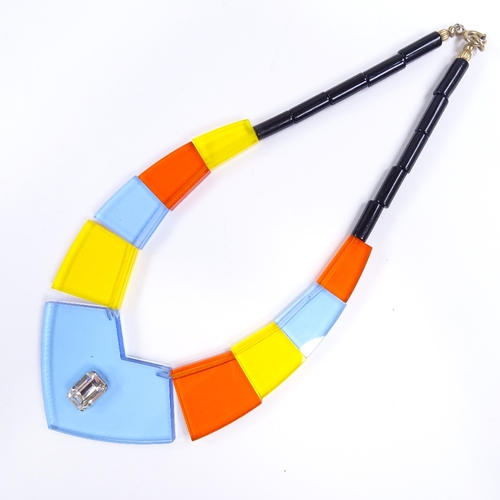 540 - A Vintage multi-colour transparent perspex panel costume necklace, inset paste stone in central pane... 