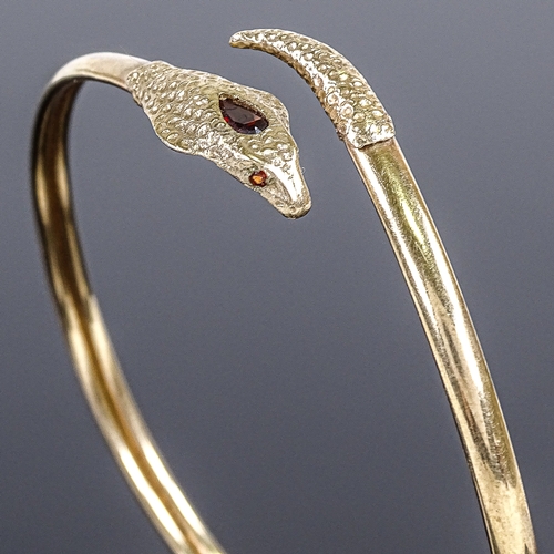 587 - A 9ct gold cobra snake/serpent torque bangle, set with a pear-cut garnet head and round-cut garnet e... 