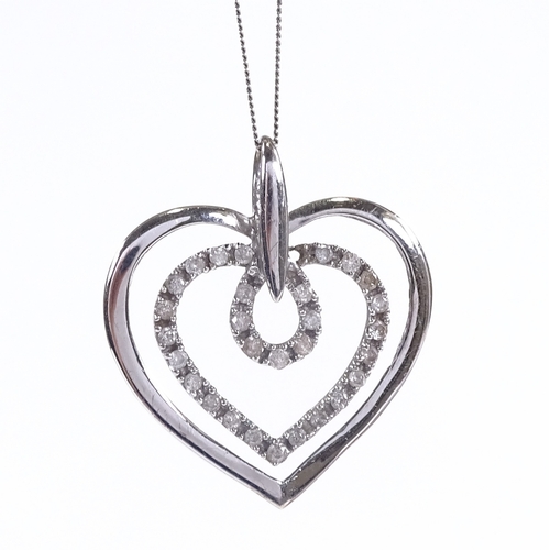 600 - A 9ct white gold diamond heart pendant necklace, on 9ct trace link chain, total diamond content appr... 