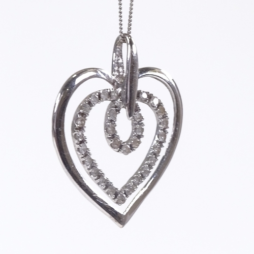 600 - A 9ct white gold diamond heart pendant necklace, on 9ct trace link chain, total diamond content appr... 