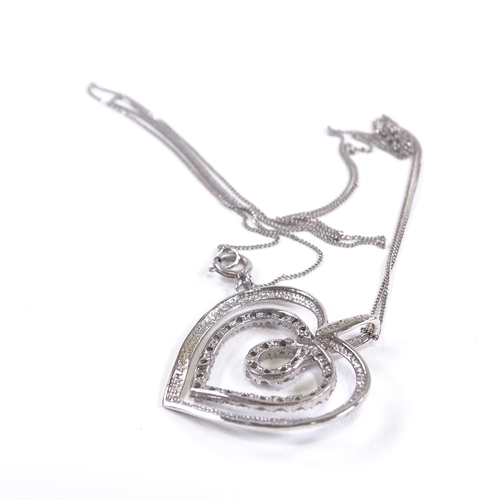 600 - A 9ct white gold diamond heart pendant necklace, on 9ct trace link chain, total diamond content appr... 