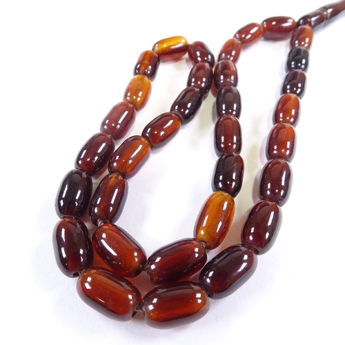 603 - A single strand of amber prayer beads, with hand knotted tassel, bead length 12.4mm, necklace length... 