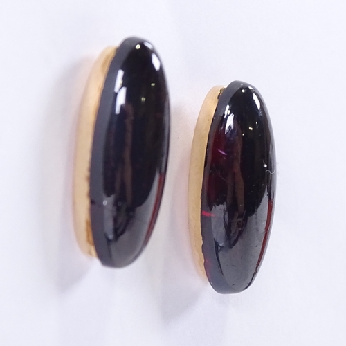 605 - A pair of unmarked gold cabochon garnet stud earrings, garnet length 18.1mm, 4.2g