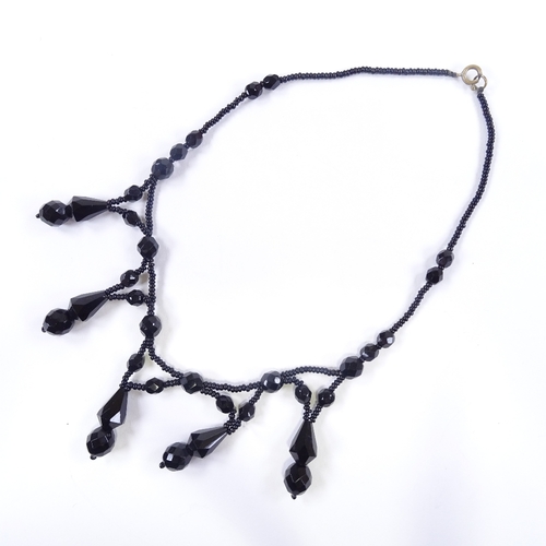 606 - A Victorian faceted jet festoon necklace, length 39cm, 24.5g