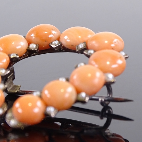 616 - A Victorian unmarked gold coral and split pearl horseshoe brooch, brooch height 34mm, 6.1g