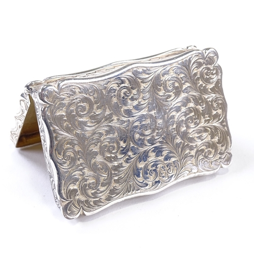 569 - A Victorian silver rectangular snuffbox, allover engraved foliate decoration with gilt interior, by ... 