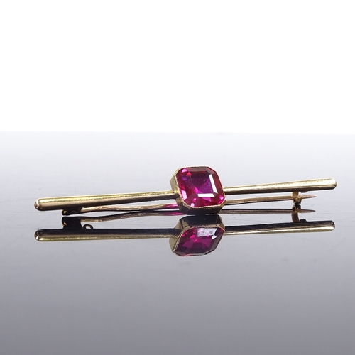 626 - An 18ct gold red stone bar brooch, brooch length 64.3mm, 4.8g