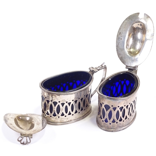 628 - A pair of late Victorian silver mustard pots, pierced decoration with blue glass liners and heart th... 