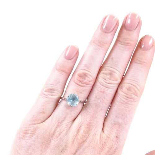 630 - A 14ct white gold blue topaz dress ring, hallmarks London 2014, maker's marks DH, setting height 10.... 