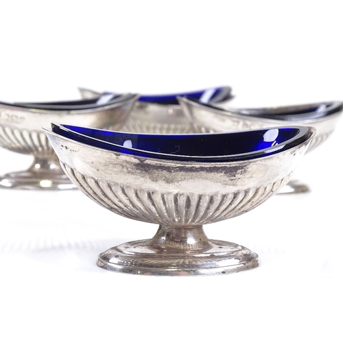 632 - A set of 4 late Victorian silver salt cellars, marquise half-fluted form with blue glass liners, by ... 