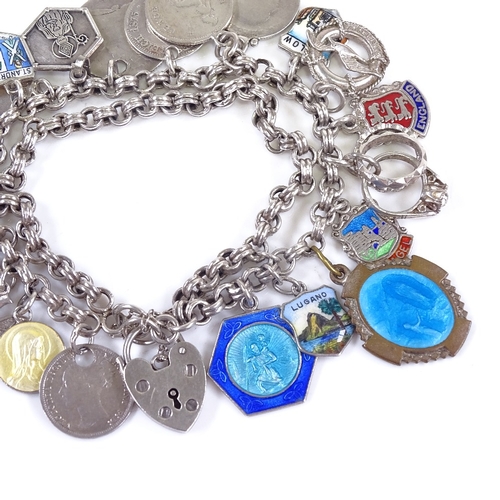 633 - A late 20th century silver heart padlock charm bracelet, double-row double-link bracelet holding 22 ... 