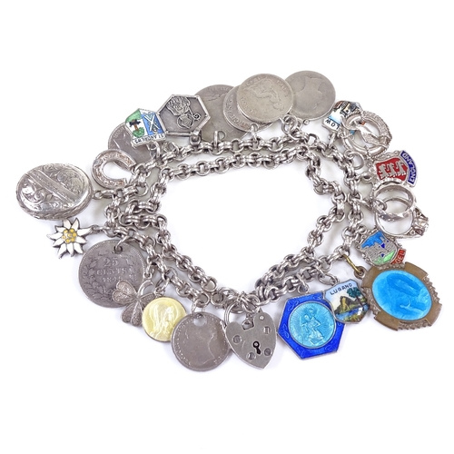 633 - A late 20th century silver heart padlock charm bracelet, double-row double-link bracelet holding 22 ... 