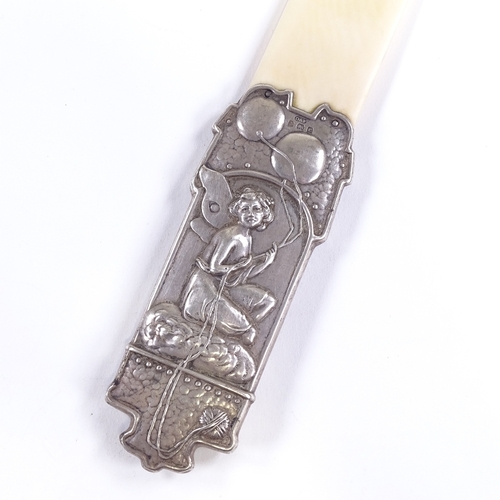 636 - An Edwardian Art Nouveau silver-handled ivory page turner, relief embossed fairy design, by Deakin &... 