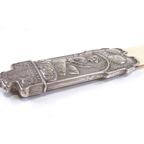 636 - An Edwardian Art Nouveau silver-handled ivory page turner, relief embossed fairy design, by Deakin &... 