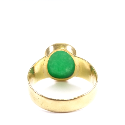 638 - A large Chinese unmarked gold cabochon green quartz ring, setting height 15.6mm, size V/W, 10.5g