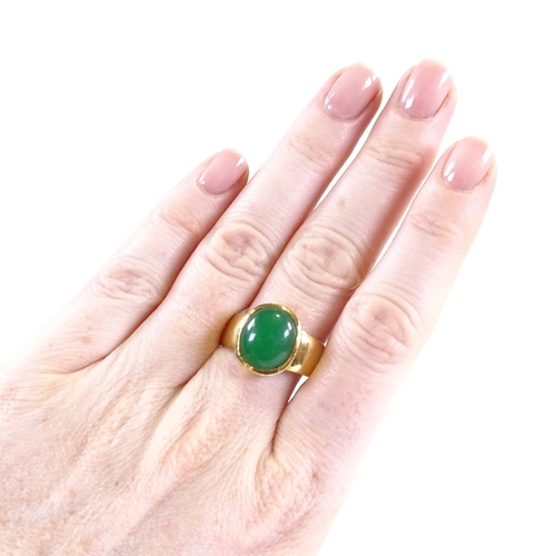 638 - A large Chinese unmarked gold cabochon green quartz ring, setting height 15.6mm, size V/W, 10.5g