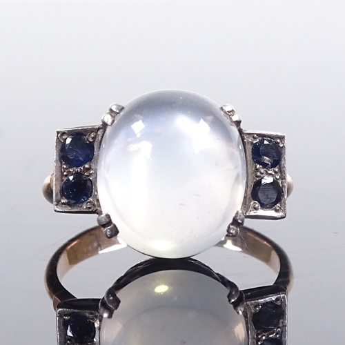 643 - A mid-20th century unmarked gold cabochon moonstone and sapphire dress ring, pierced shoulders and b... 