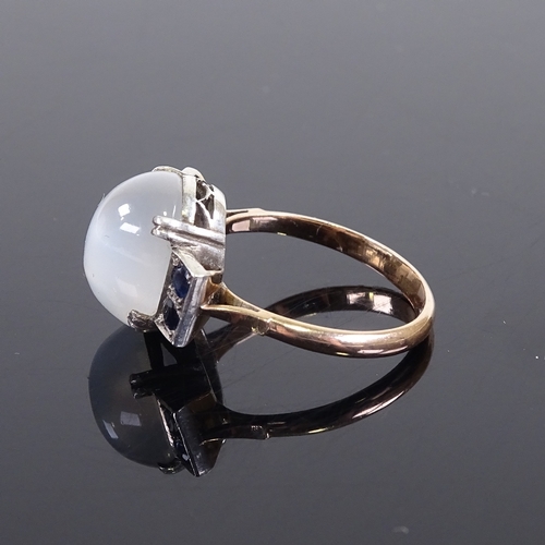 643 - A mid-20th century unmarked gold cabochon moonstone and sapphire dress ring, pierced shoulders and b... 