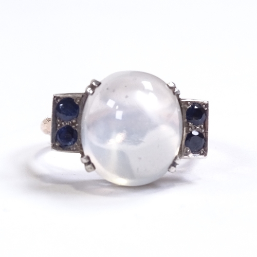 643 - A mid-20th century unmarked gold cabochon moonstone and sapphire dress ring, pierced shoulders and b... 