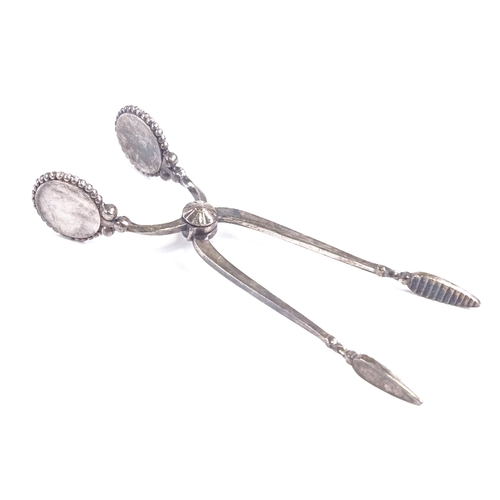 645 - GEORG JENSEN - a pair of Danish sterling silver Kugel pattern sugar tongs, beaded edge with sprung c... 