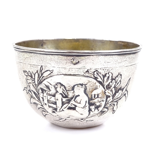 646 - An early 18th century German unmarked parcel gilt silver tumbler cup, relief embossed maiden playing... 