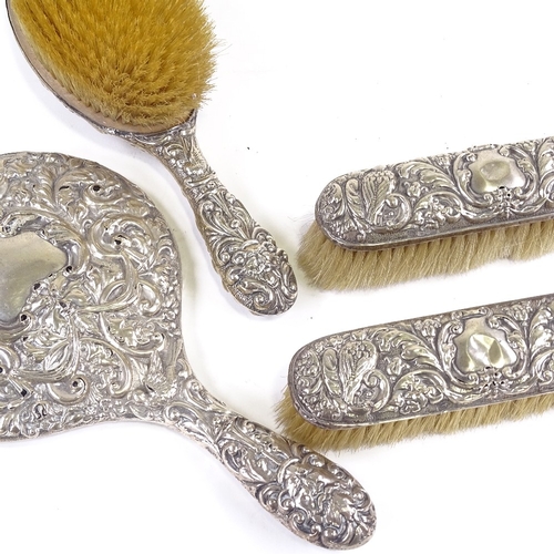 657 - An Edwardian 4-piece silver-backed dressing table set, comprising hand mirror, hand brush and pair o... 