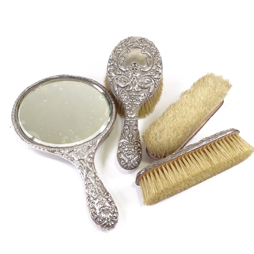 657 - An Edwardian 4-piece silver-backed dressing table set, comprising hand mirror, hand brush and pair o... 