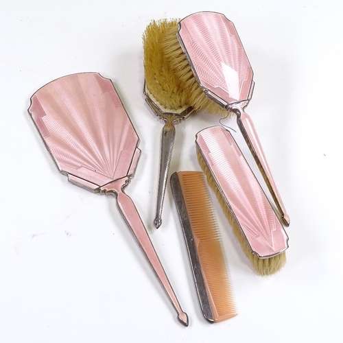 667 - An Art Deco 5-piece silver-back pink enamel dressing table set, comprising hand mirror, 2 hand brush... 