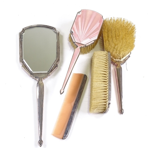 667 - An Art Deco 5-piece silver-back pink enamel dressing table set, comprising hand mirror, 2 hand brush... 