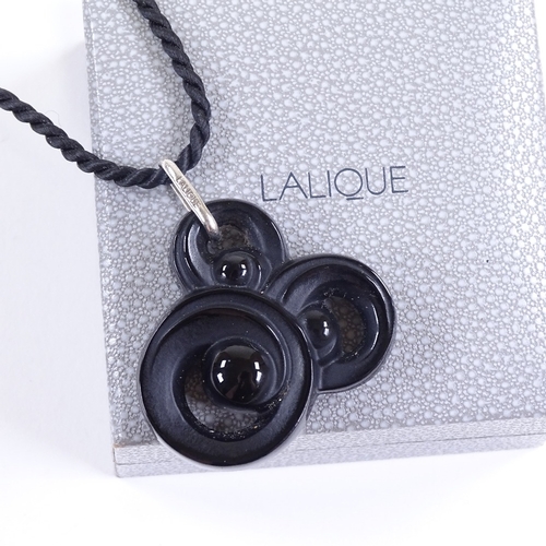 679 - LALIQUE - a modern black moulded crystal glass pendant necklace, on rope twist chain with sterling s... 