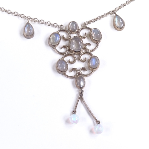 686 - A modern sterling silver cabochon moonstone and opal drop pendant necklace, stylised settings with p... 