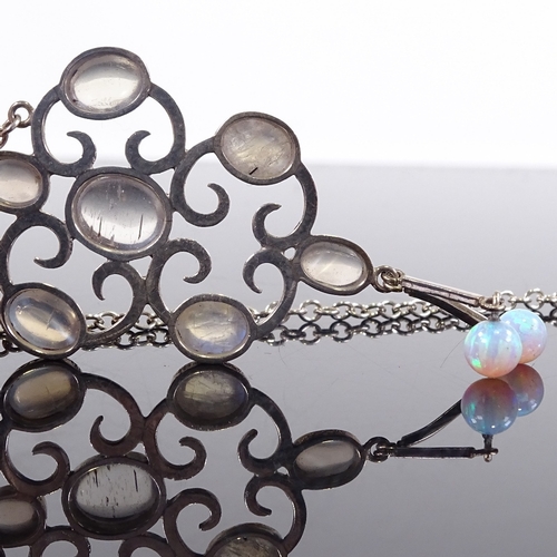 686 - A modern sterling silver cabochon moonstone and opal drop pendant necklace, stylised settings with p... 