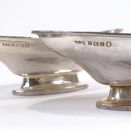 696 - A pair of George V silver boat-shaped pedestal bowls, engraved star rim, by Hukin & Heath, Jubilee h... 